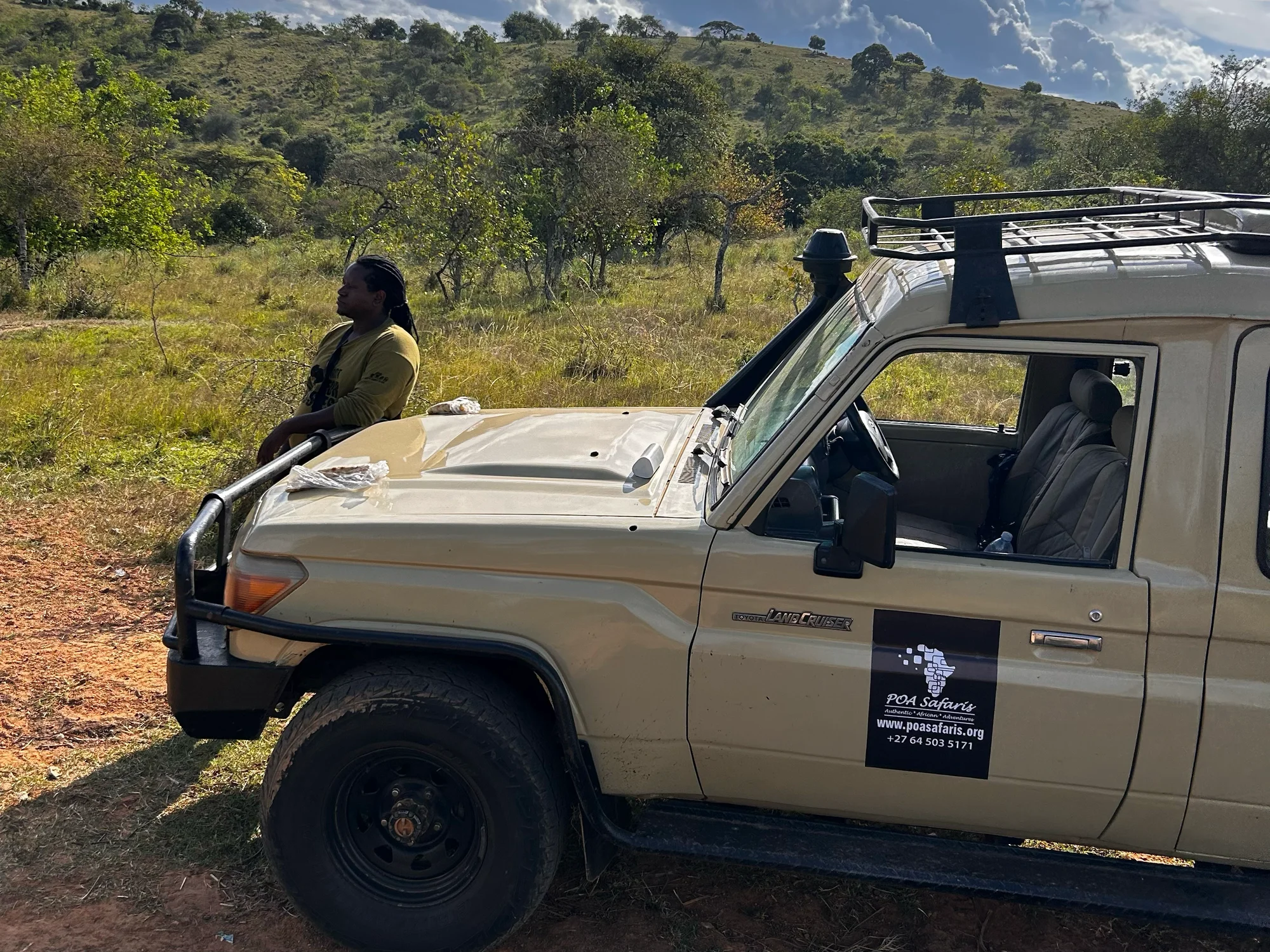 Doctor Mukote beside the POA Safaris Land Cruiser